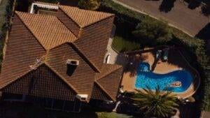picture of tile roof in florida with pool and man on floater