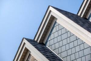dormers on roof with dark asphalt shingles