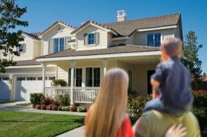 Young Family Looking at a Beautiful New Home.