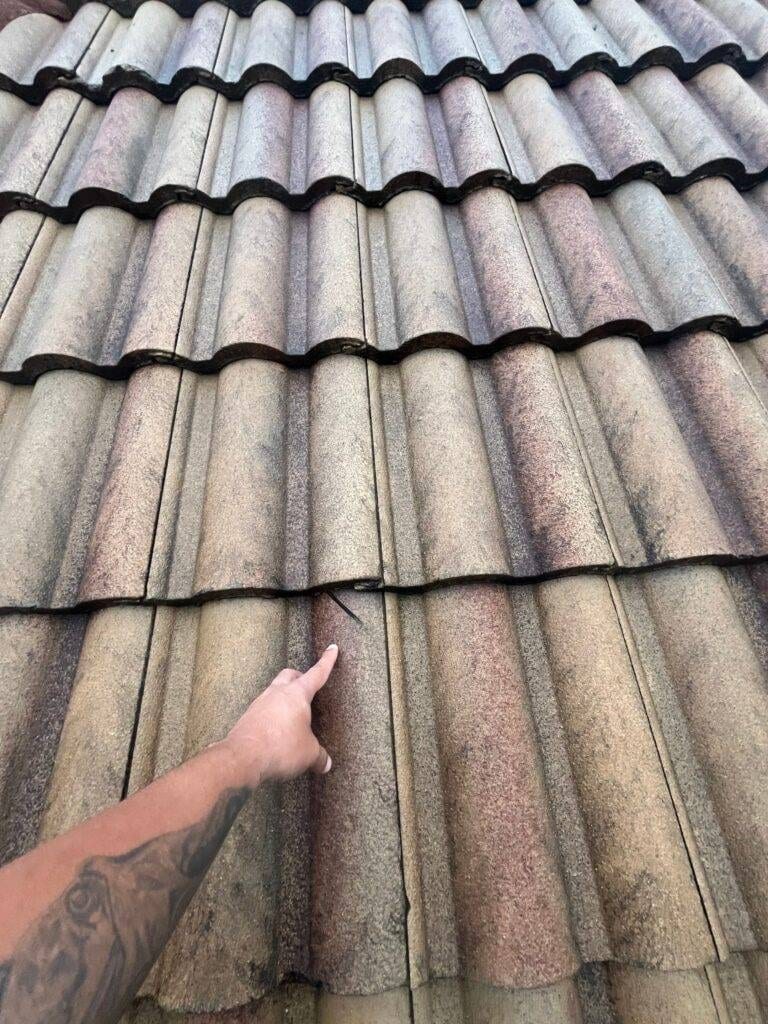 pointing at damage on a tile roof
