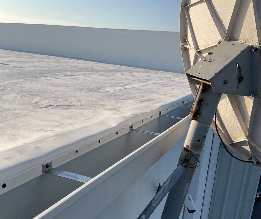up close of gutters installed on a flat roof in florida