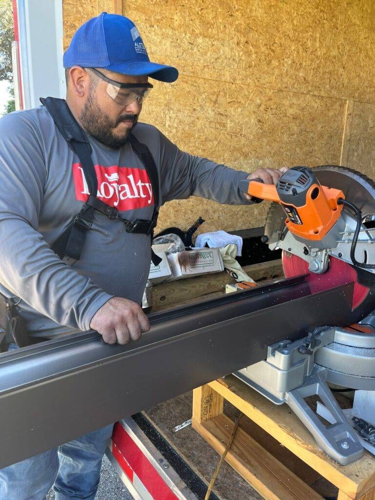 royalty roof worker cutting metal roof piece to size fort myers
