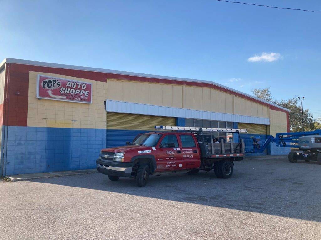 replacement of metal awning on auto business in florida with royalty truck parked out front