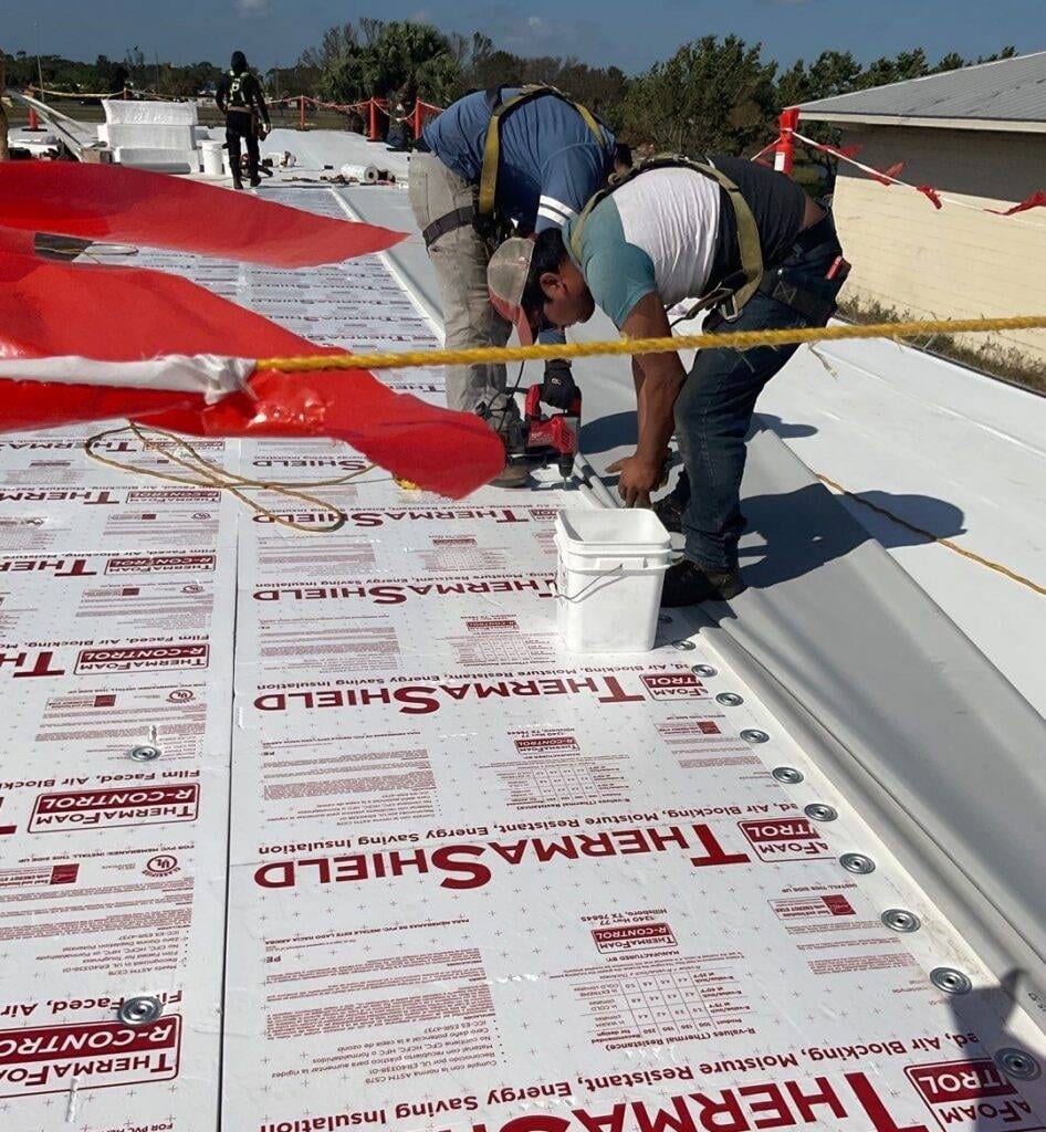 royalty roofers installing duro-last single-ply panels over thermashield on flat roof