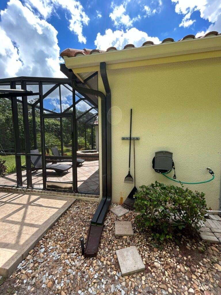 black gutters and downspout on home