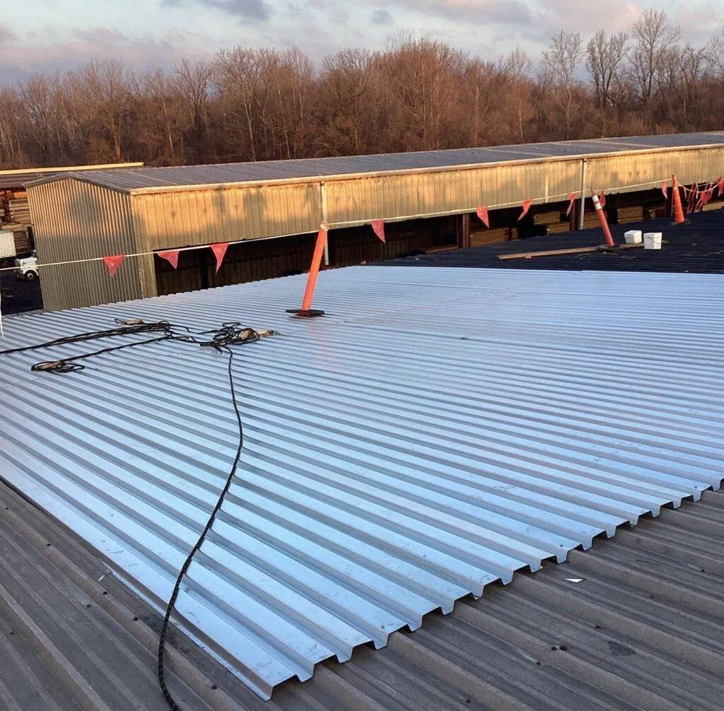 metal roof sheet overlaying old metal roof during replacement