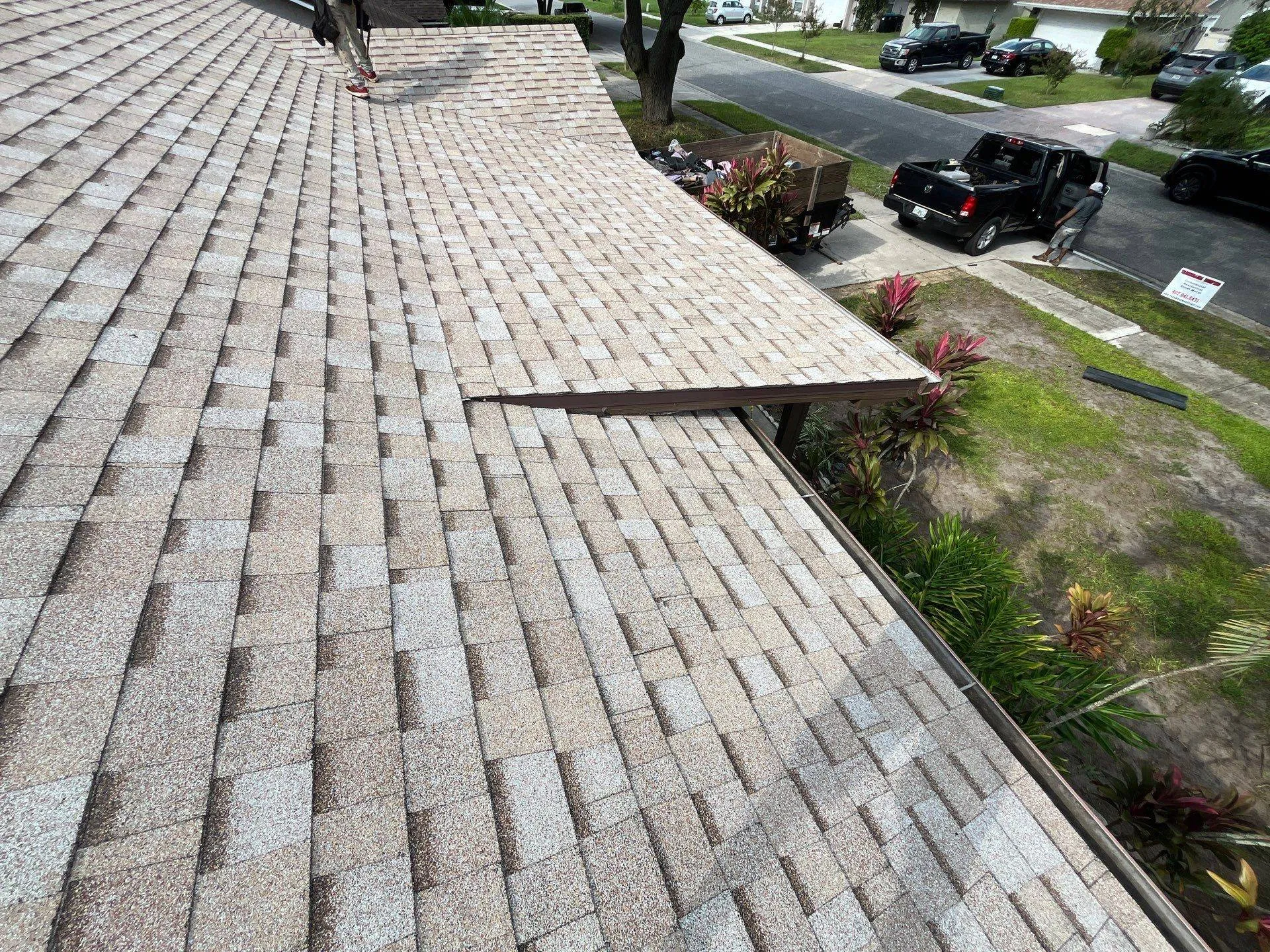 new shingle roof in Florida on home with royalty roof workers cleaning up