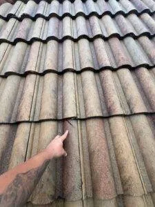 pointing at damage on a tile roof