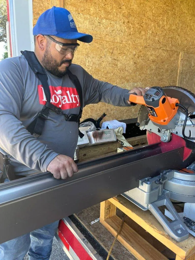 royalty roof worker cutting metal roof piece to size fort myers